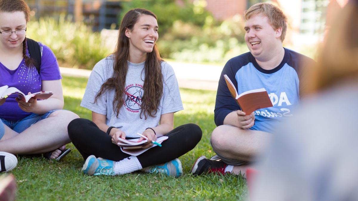 Students read together on the lawn of Northrup Hall.